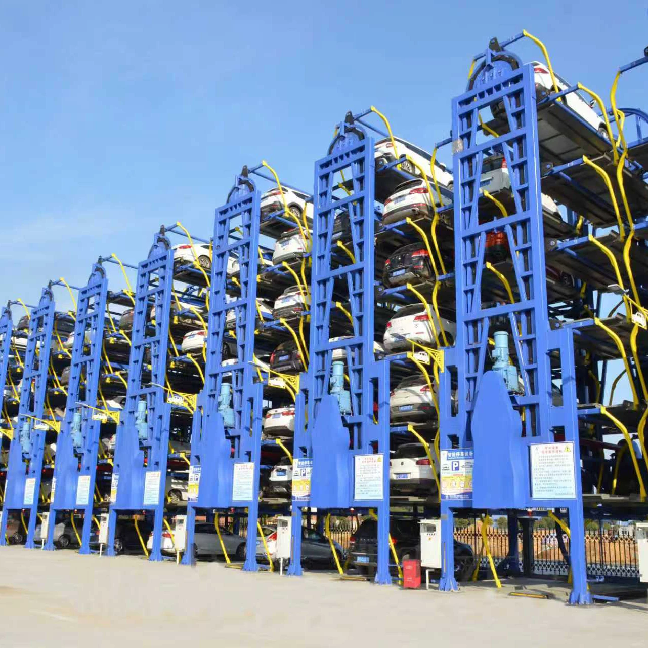 Blue vertical circulation parking system with multiple cars in an outdoor parking lot, a high-density automated parking solution.